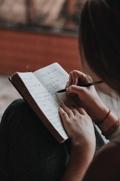 Woman writing in a book